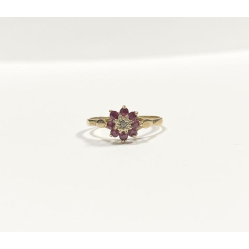 158 - A BEAUTIFUL DAINTY 9CT YELLOW GOLD DIAMOND & RUBY CLUSTER RING, with central illusion set round cut ... 