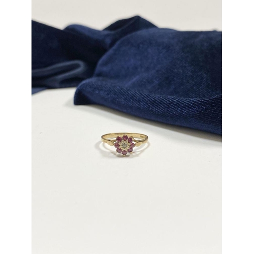 158 - A BEAUTIFUL DAINTY 9CT YELLOW GOLD DIAMOND & RUBY CLUSTER RING, with central illusion set round cut ... 