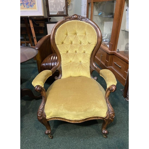 162 - A VICTORIAN MAHOGANY UPHOLSTERED BUTTON BACK ARMCHAIR, the mahogany frame with carved crest to top, ... 