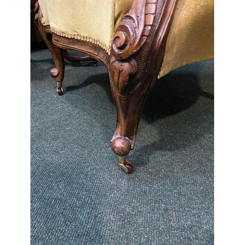 162 - A VICTORIAN MAHOGANY UPHOLSTERED BUTTON BACK ARMCHAIR, the mahogany frame with carved crest to top, ... 