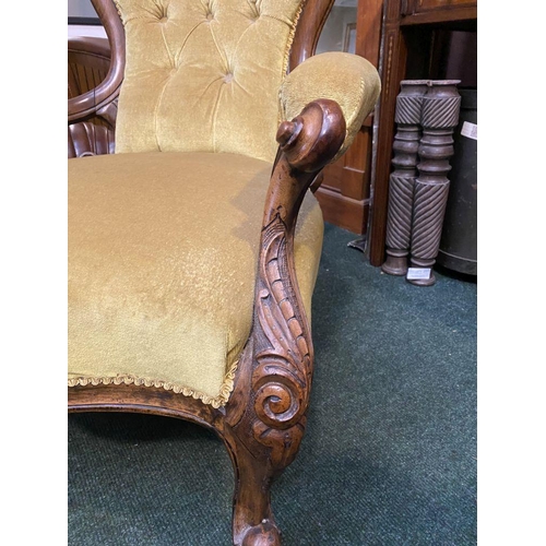 162 - A VICTORIAN MAHOGANY UPHOLSTERED BUTTON BACK ARMCHAIR, the mahogany frame with carved crest to top, ... 