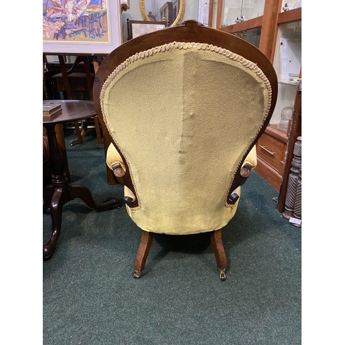 162 - A VICTORIAN MAHOGANY UPHOLSTERED BUTTON BACK ARMCHAIR, the mahogany frame with carved crest to top, ... 