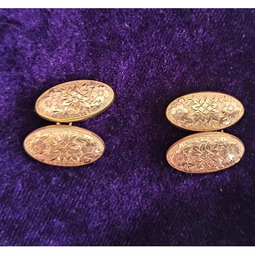 167 - A VINTAGE PAIR OF 9CT YELLOW GOLD CUFFLINKS, decorated with floral design, oval in shape.