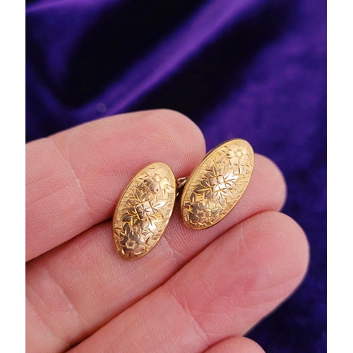 167 - A VINTAGE PAIR OF 9CT YELLOW GOLD CUFFLINKS, decorated with floral design, oval in shape.