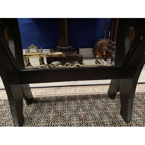 181 - A DARK STAINED HARDWOOD STOOL/BENCH, with shaped supports joined by a cross stretcher. The supports ... 