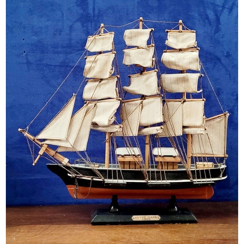 206 - A NEATLY SIZED WOODEN MODEL OF THE CUTTY SARK, 1869. Fantastic detail in the rigs and sails. Mounted... 