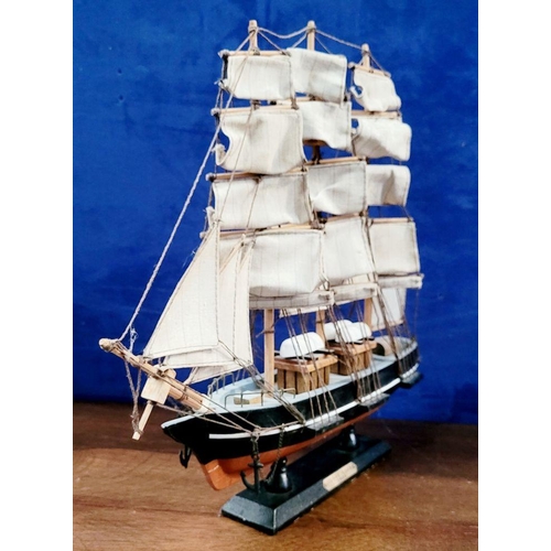 206 - A NEATLY SIZED WOODEN MODEL OF THE CUTTY SARK, 1869. Fantastic detail in the rigs and sails. Mounted... 