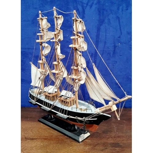 206 - A NEATLY SIZED WOODEN MODEL OF THE CUTTY SARK, 1869. Fantastic detail in the rigs and sails. Mounted... 