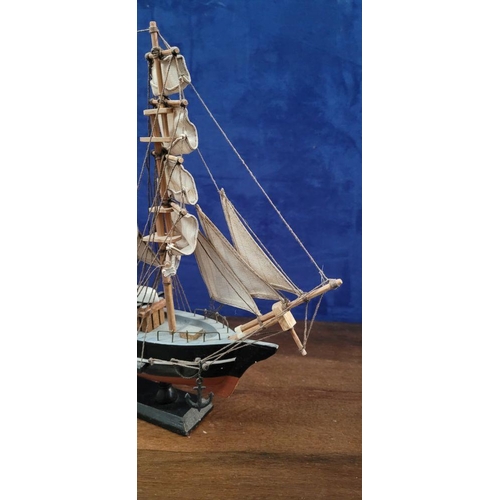 206 - A NEATLY SIZED WOODEN MODEL OF THE CUTTY SARK, 1869. Fantastic detail in the rigs and sails. Mounted... 