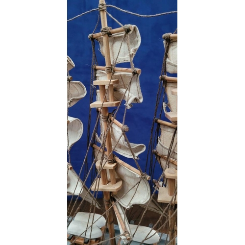 206 - A NEATLY SIZED WOODEN MODEL OF THE CUTTY SARK, 1869. Fantastic detail in the rigs and sails. Mounted... 