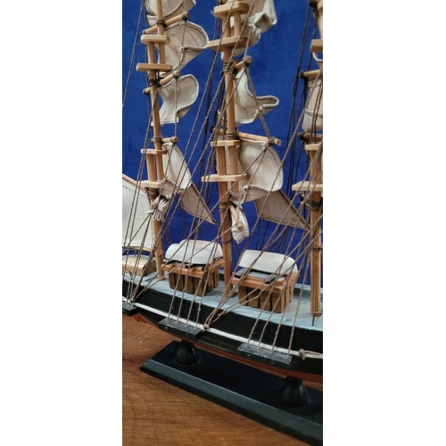 206 - A NEATLY SIZED WOODEN MODEL OF THE CUTTY SARK, 1869. Fantastic detail in the rigs and sails. Mounted... 