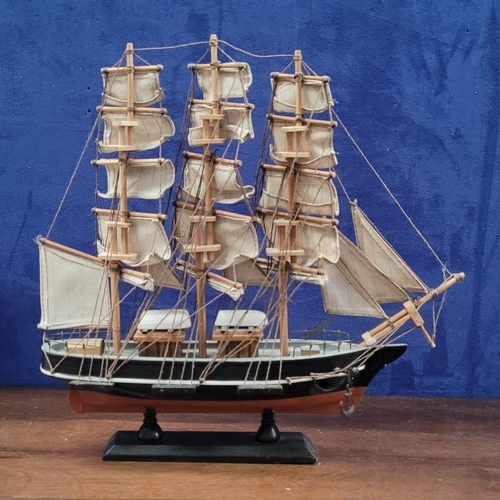 206 - A NEATLY SIZED WOODEN MODEL OF THE CUTTY SARK, 1869. Fantastic detail in the rigs and sails. Mounted... 