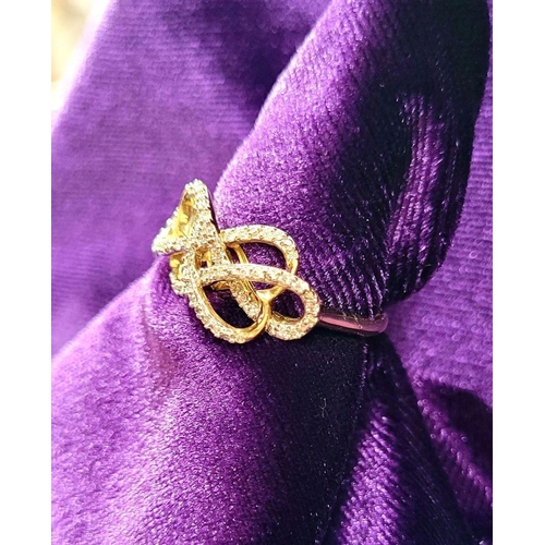 21 - A LOVELY 10CT YELLOW GOLD & DIAMOND DOUBLE INFINITY KNOT RING, a really pretty design, with a ribbon... 