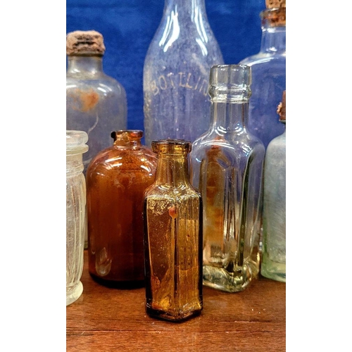 216 - A LARGE COLLECTION OF ANTIQUE IRISH GLASS JARS/BOTTLES, includes mostly clear glass with a few brown... 