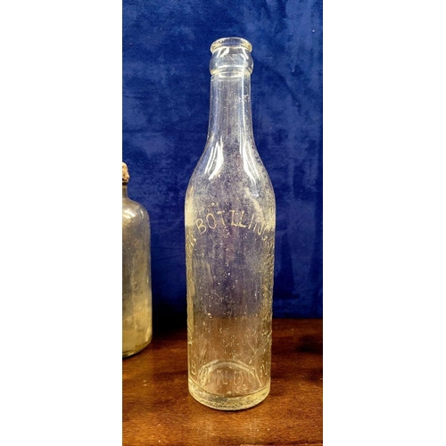 216 - A LARGE COLLECTION OF ANTIQUE IRISH GLASS JARS/BOTTLES, includes mostly clear glass with a few brown... 