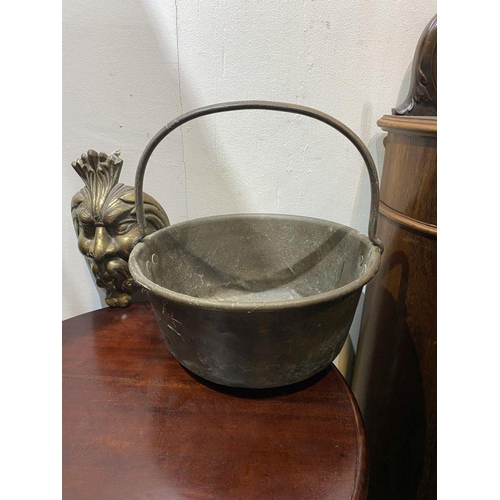 240 - A HEAVY BRASS POT ALONG WITH CAST METAL MASK, dimensions: pot: 33cm diameter; mask: 25.5cm high appr... 