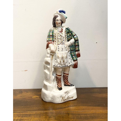 241 - A LARGE LATE 19TH CENTURY STAFFORDSHIRE FIGURE OF SIR WILLIAM WALLACE. The figure is standing on a s... 