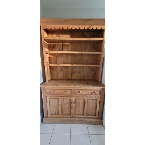 25 - A VERY GOOD IRISH PITCH PINE DRESSER, with pediment top over 3 open shelves; each with a raised lip ... 