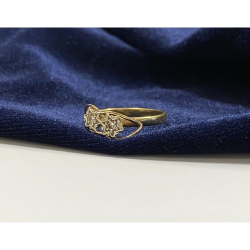 36 - A PRETTY 9CT YELLOW GOLD TWO STONE DIAMOND RING, with two round cut diamonds in decorative star sett... 