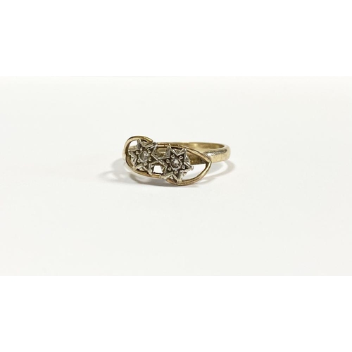 36 - A PRETTY 9CT YELLOW GOLD TWO STONE DIAMOND RING, with two round cut diamonds in decorative star sett... 