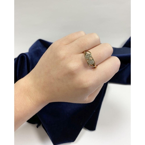 36 - A PRETTY 9CT YELLOW GOLD TWO STONE DIAMOND RING, with two round cut diamonds in decorative star sett... 