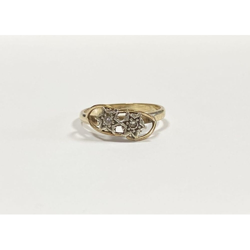 36 - A PRETTY 9CT YELLOW GOLD TWO STONE DIAMOND RING, with two round cut diamonds in decorative star sett... 