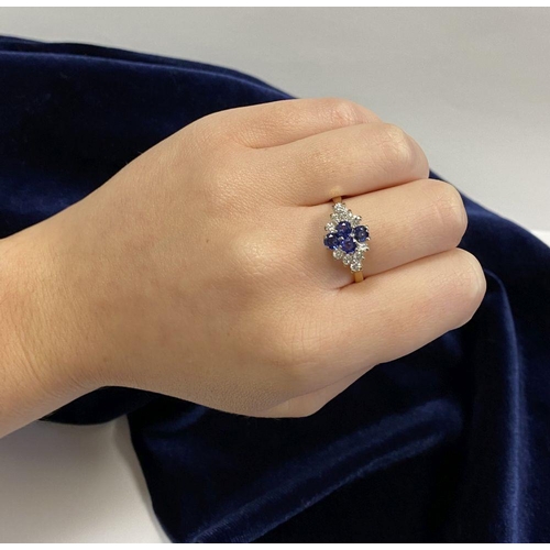 4 - A FANTASTIC 18CT YELLOW GOLD SAPPHIRE & DIAMOND CLUSTER RING, with four round cut vibrant sapphires ... 