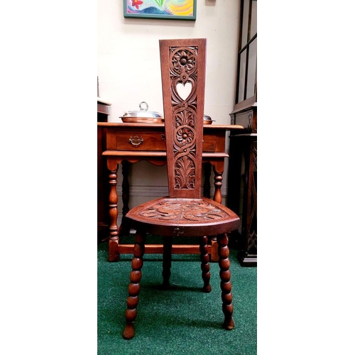 48 - A HAND CARVED ARTS ‘N’ CRAFTS OAK SPINNING CHAIR, with a tall tapered carved panel back, showing flo... 