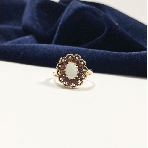 51 - AN ANTIQUE 9CT YELLOW GOLD OPAL & GARNET CLUSTER RING, with central oval cut claw set opal surrounde... 