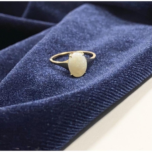 55 - AN ELEGANT 9CT YELLOW GOLD OPAL SOLITAIRE RING, with oval cut opal in raised four prong claw setting... 