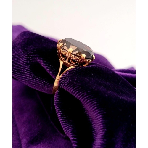 62 - A FANTASTIC VINTAGE 9CT YELLOW GOLD SMOKEY QUARTZ RING, the large oval shaped quartz is set within a... 