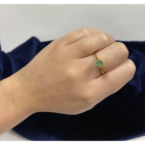 69 - A PRETTY 18CT YELLOW GOLD OVAL CUT EMERALD SOLITAIRE RING, with oval cut emerald in raised six prong... 