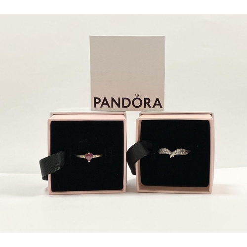 84 - TWO BOXED SILVER PANDORA RINGS, one with a heart cut pink gemstone in claw setting, the other with c... 