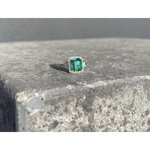 9 - AN 18CT WHITE GOLD COLOMBIAN EMERALD & DIAMOND RING, with a magnificent emerald cut natural Colombia... 