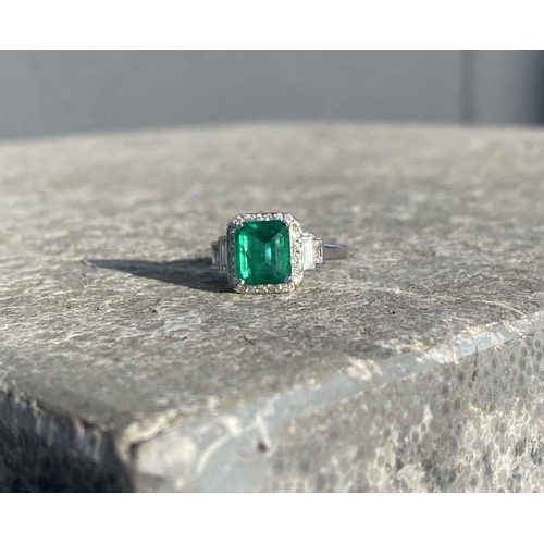 9 - AN 18CT WHITE GOLD COLOMBIAN EMERALD & DIAMOND RING, with a magnificent emerald cut natural Colombia... 