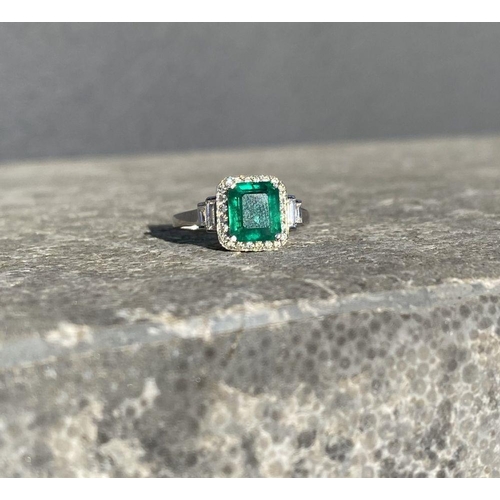 9 - AN 18CT WHITE GOLD COLOMBIAN EMERALD & DIAMOND RING, with a magnificent emerald cut natural Colombia... 