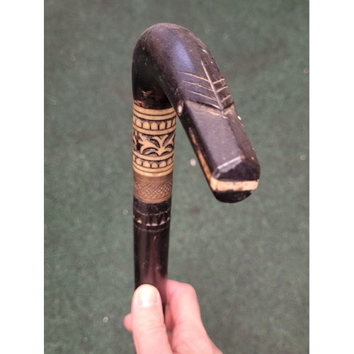 255 - AN ANTIQUE INDIAN CANE, with carved handle in the form of an animal head, with inlaid bone details, ... 