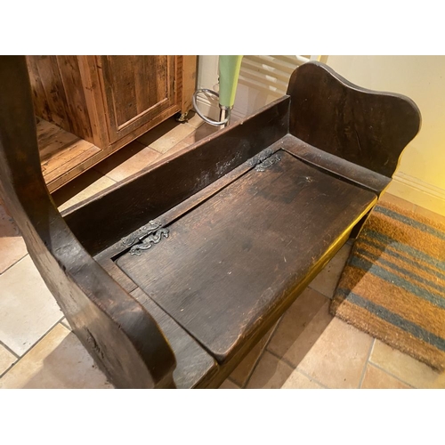 259 - A PAIR OF CARVED ANTIQUE MUNK STYLE BENCHES, with wrought iron hinged lift top cabinet lids to the s... 