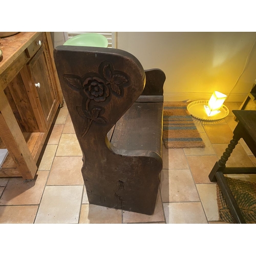 259 - A PAIR OF CARVED ANTIQUE MUNK STYLE BENCHES, with wrought iron hinged lift top cabinet lids to the s... 