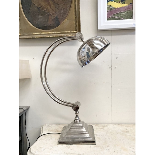 100 - A 1960s CHROME TABLE LAMP with dome shade on adjustable arm support raised on a square stepped base.... 