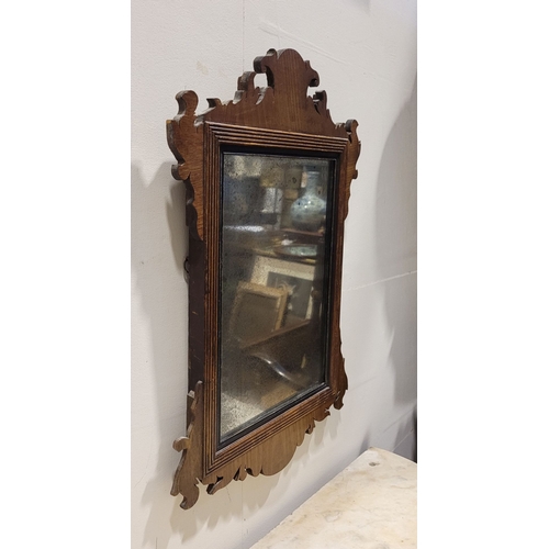110 - AN ANTIQUE NEATLY SIZED CHIPPENDALE STYLE WALL MIRROR, typical scrolling foliate design to the frame... 