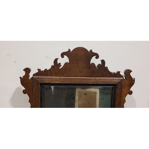 110 - AN ANTIQUE NEATLY SIZED CHIPPENDALE STYLE WALL MIRROR, typical scrolling foliate design to the frame... 