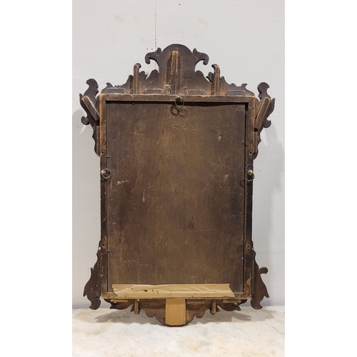 110 - AN ANTIQUE NEATLY SIZED CHIPPENDALE STYLE WALL MIRROR, typical scrolling foliate design to the frame... 