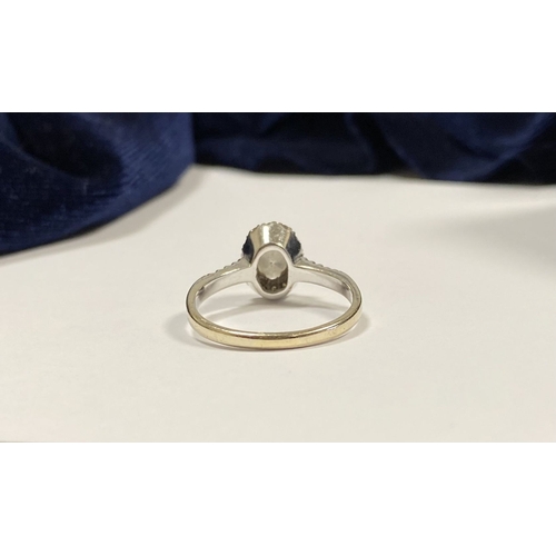 14 - A STUNNING 14CT WHITE GOLD DIAMOND CLUSTER RING, with central oval brilliant cut diamond, weight: .5... 