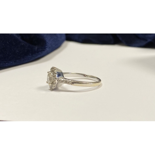 14 - A STUNNING 14CT WHITE GOLD DIAMOND CLUSTER RING, with central oval brilliant cut diamond, weight: .5... 