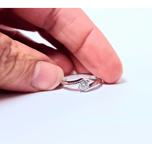 15 - A BEAUTIFUL 18CT WHITE GOLD DIAMOND SOLITAIRE RING, with a crossover setting, 18ct white gold band. ... 