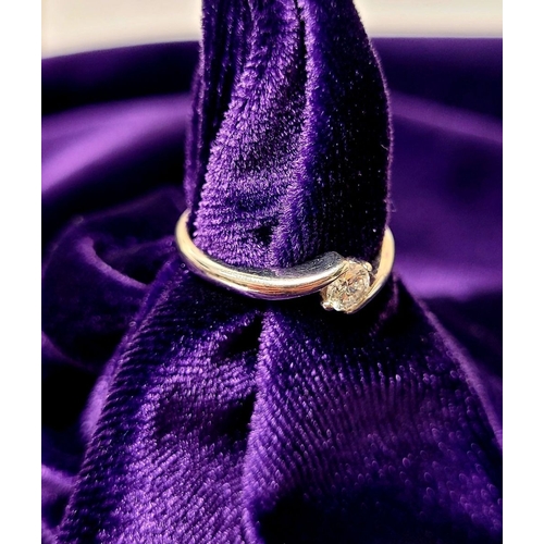 15 - A BEAUTIFUL 18CT WHITE GOLD DIAMOND SOLITAIRE RING, with a crossover setting, 18ct white gold band. ... 