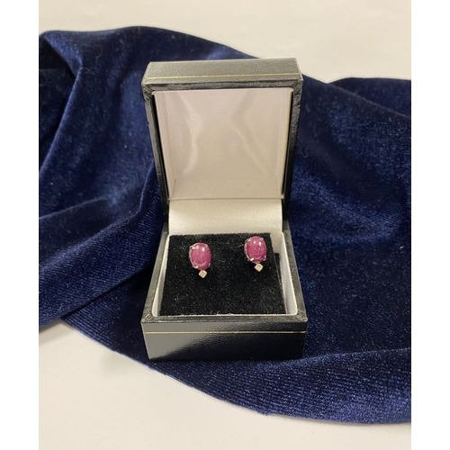 16 - A PAIR OF 18CT WHITE GOLD RUBY & DIAMOND STUD EARRINGS, with oval cut rubies in four prong claw sett... 