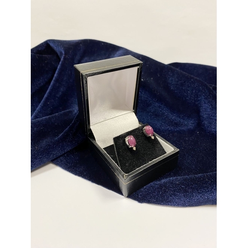 16 - A PAIR OF 18CT WHITE GOLD RUBY & DIAMOND STUD EARRINGS, with oval cut rubies in four prong claw sett... 