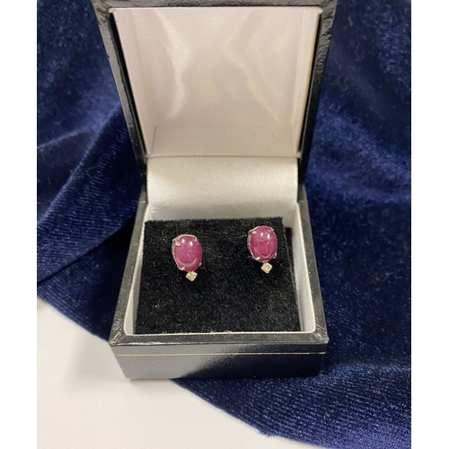 16 - A PAIR OF 18CT WHITE GOLD RUBY & DIAMOND STUD EARRINGS, with oval cut rubies in four prong claw sett... 